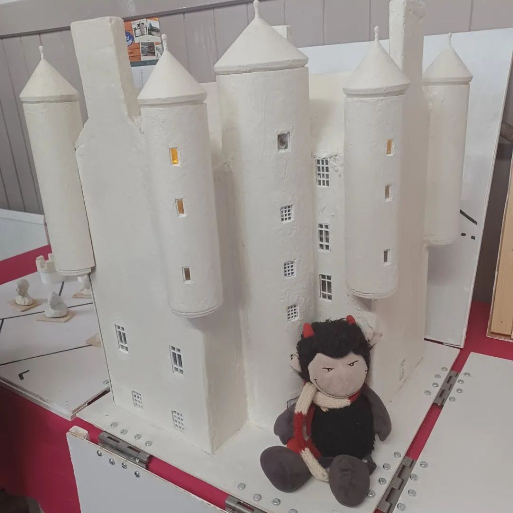A photo of the new model of Braemar Castle.  It is white and has many turrets. 