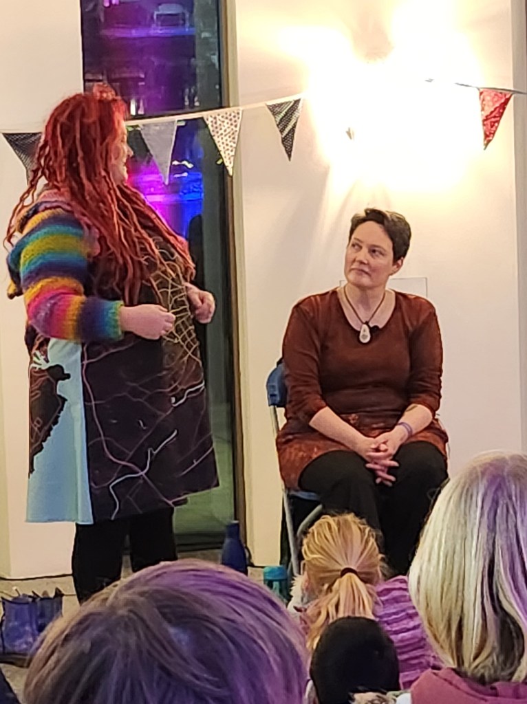 Pauline Cordiner and Lindsey Gibb tell stories at Spectra Light Festival 2023.
Pauline looks at Lindsey mid story. 